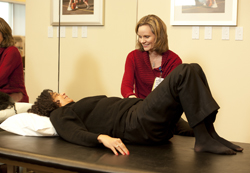patient with lower back pain at a physical therapy session to minimize chance of spine surgery